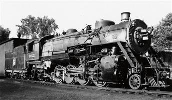 (LOCOMOTIVES) Pair of albums with more than 325 snapshots of trains from all angles and in all types of weather,